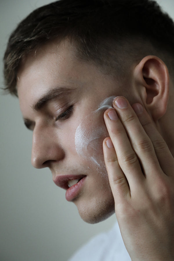 Image of a man applying ChitoCare Beauty face cream to his cheekbones